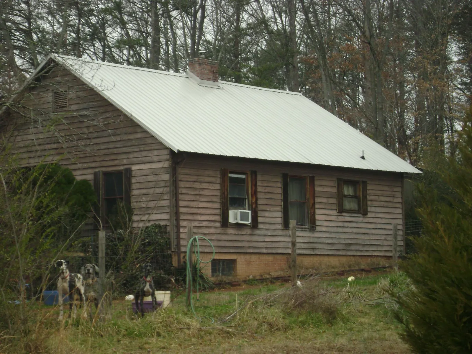 White metal roof on an old wood sided farmhouse, from a Metal Roof Installation job in Avon Lake